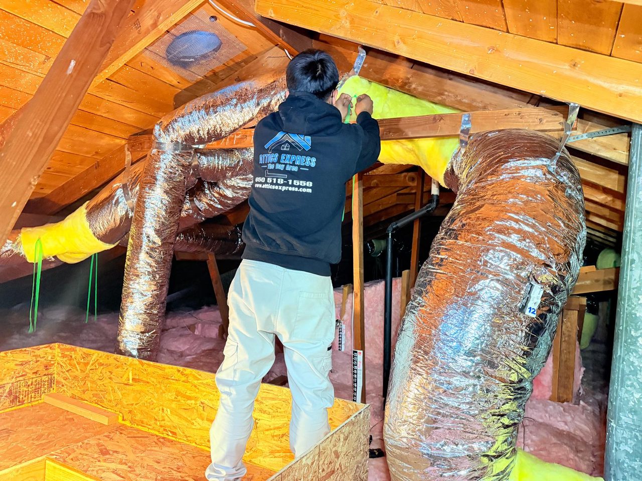Rodent proofing technician sealing an attic entry point